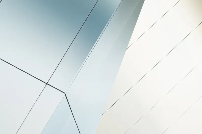 Intersecting white planes of a building exterior.